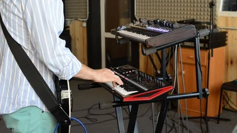 Man playing synthesizer, keyboard and guitar Stock Footage 101114317