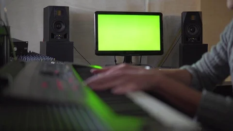 Man playing on synthesizer in Studio on green screen Stock Footage 72446152