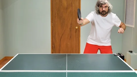 Man playing table tennis with robot automatic feed balls system Stock Footage 127788108