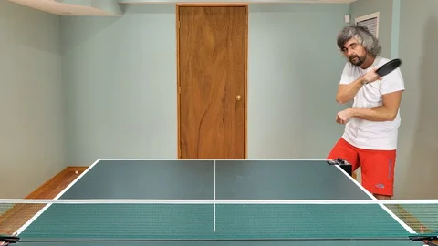 Man playing table tennis with robot automatic feed balls system Stock Footage 127851835