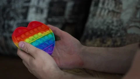 Man playing with toy pop it simple dimple in the house Stock Footage 165214426
