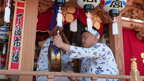 A man playing a traditional percussion instrument at Tenjin Matsuri festival Stock Footage 337099343