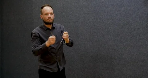 Man playing triangle, half body shot, caucasian male with beard and grey shirt,  Stock-Footage 105916170