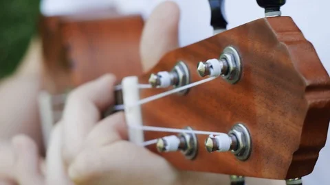 Man playing on ukulele at nature close-up hands and music instrument. Stockbeeldmateriaal 108389705