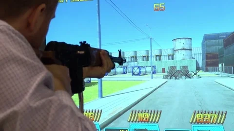 Man playing video arcade shooting rifle range game Stock Footage 76876818