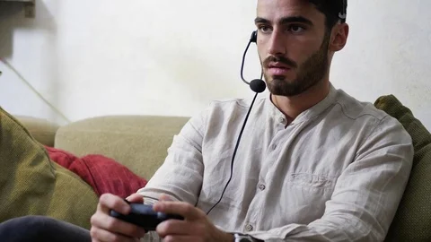 Man playing video game and talking with online players Stock Footage 80824094