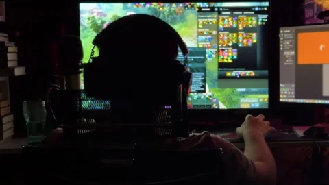 Man playing video game at computer in the dark gaming night Stock Footage 317958073