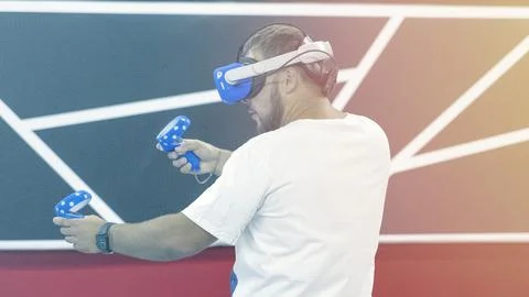 A man is playing a video game with a controller in his hand Stock Photos