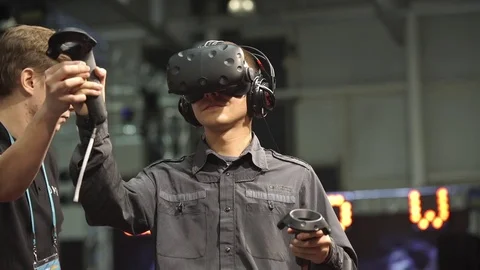 Man playing video game with HTC Vive VR headset Stock Footage 80876133