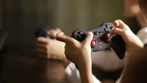 Man playing video game with a joystick. close-up of children's hands Stock Footage