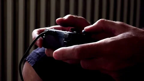 A man playing a video game with a joystick. Close up of children's hands 스톡 동영상 334653406
