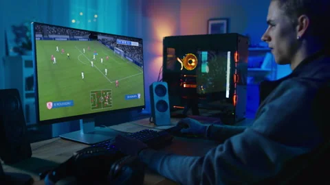 Man Playing Video Game Soccer on Desktop Computer Stock Footage 321011317