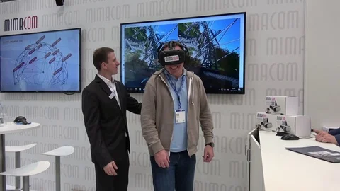 Man playing video game in virtual reality headset developed by HTC Vive on Stock Footage 74392598
