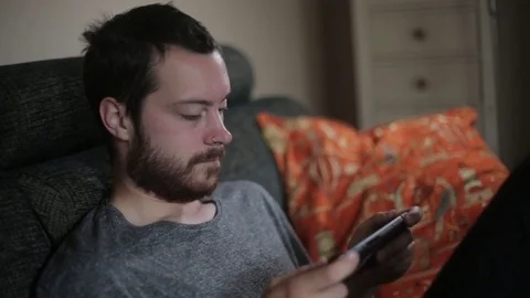 Man Playing Video Games on Portable Device Stock Footage 76688055