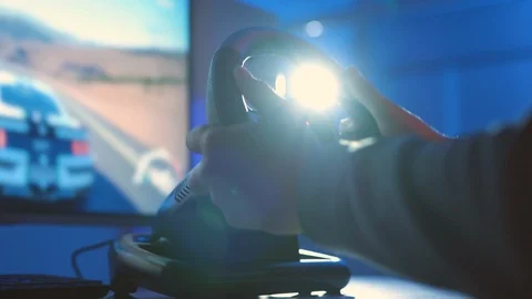 The man playing video games with steering wheel Stock Footage 127259495