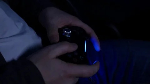 Man playing with a videogame controller in his hands Video stock 84954486