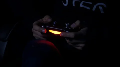 Man playing with a videogame controller in his hands Stock Footage 86074284