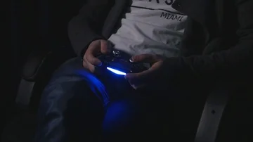 Man playing with a videogame controller in his hands Video stock 86074437