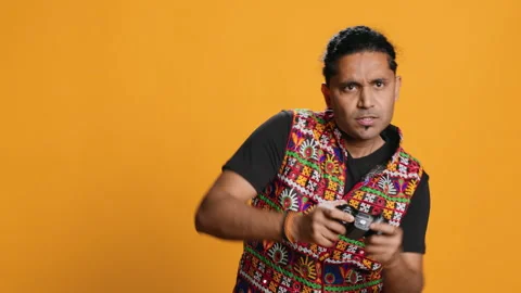Man playing videogames with controller, studio background Stock Footage 274766137