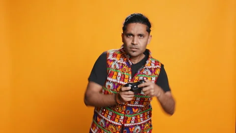 Man playing videogames with controller, studio background Stock Footage 274851072