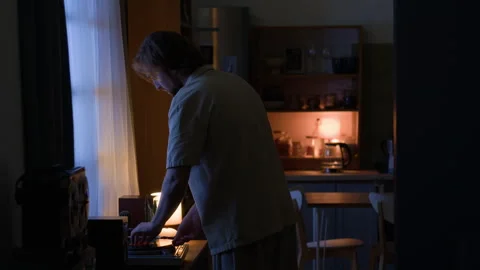 Man Playing Vinyl Record on Turntable for Evening Routine at Home Stock Footage 345516403