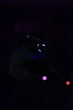 Man playing virtual reality on a dark background Stock Photos