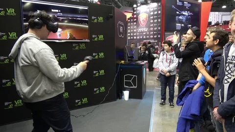 Man playing virtual reality game in HTC Vive VR headset with accessories Stock Footage 83220790