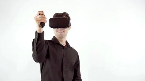 Man playing in virtual reality goggles. Studio video, white background Video stock 70058693
