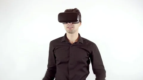 Man playing in virtual reality goggles. Studio video, white background Video stock 70079473