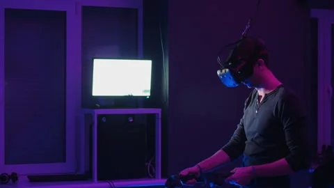 Man playing VR game with headset and controllers Stock Footage 316758130