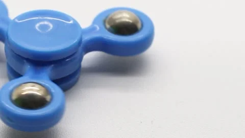 A man plays a blue spinner Stock Footage 268883649