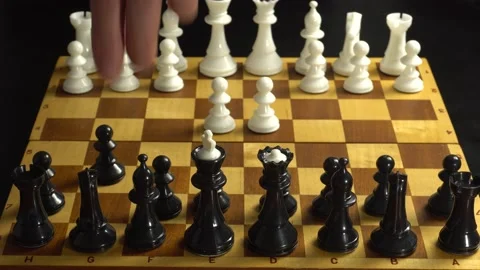 Man plays chess with himself playing the debut combinations on the book Stock Footage 142835952