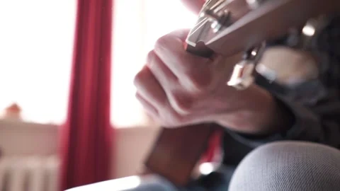 A man plays the classical guitar. Beautiful rays of sun in the background Stock Footage 273481501