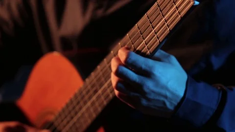Man plays classical guitar,close-up of guitar strings and fretboard,isolated Stock Footage 121583714