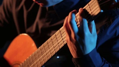 Man plays classical guitar,close-up of guitar strings and fretboard,isolated 库存影片 121583715