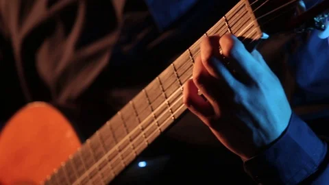 Man plays classical guitar,close-up of guitar strings and fretboard,isolated Stock Footage 121583738