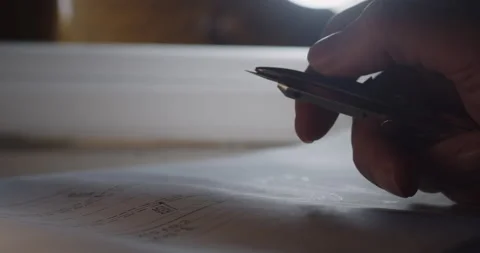 A man plays with a compass over a construction drawing. Close-up shot Stock Footage 211733695