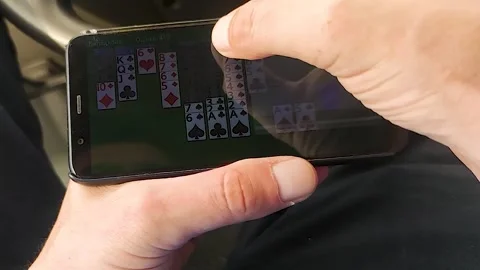 A Man Plays a Computer Game on a Smartphone.  Stock Footage 247164240