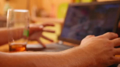 Man plays computer games on a computer, shows the symbol fuck in the monitor Stock Footage 120092001
