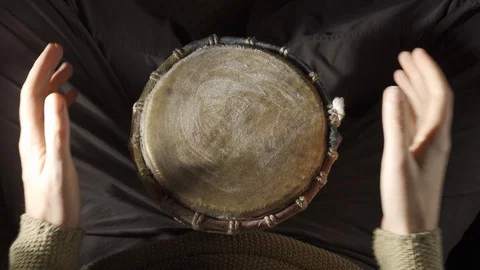Man plays the djembe drum covered wit powder, top and first person view Stock Footage 114063749