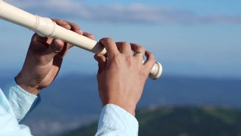 A man plays a flute Stock Footage 135792185