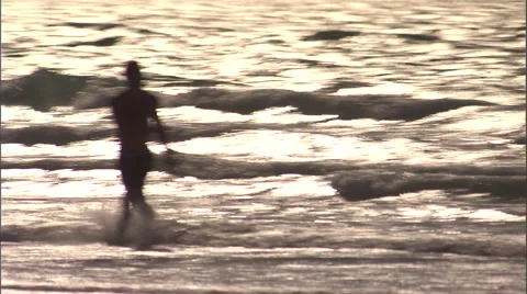 A man plays with a frisbee on the beach. Stock Footage 46867210