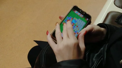 A man plays the game of balls on a smartphone Stock Footage 218973133