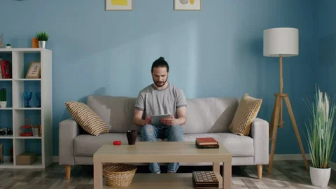 Man Plays Game on Tablet Computer Stock Footage 129895511