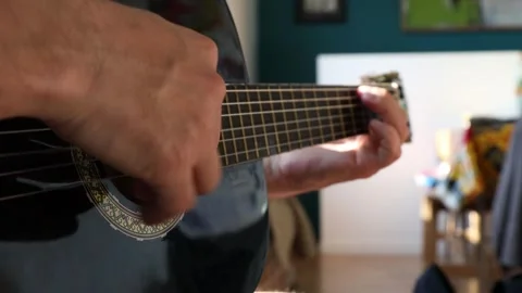 The man plays the guitar. Close-up. Stock Footage 244877813