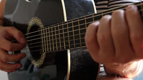 The man plays the guitar. Close-up. Stock Footage 244877856