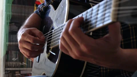 The man plays the guitar. Close-up. Stock Footage 244878324