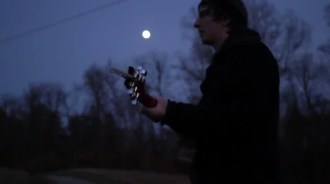 Man Plays Guitar at Dusk Stock Footage 61645982