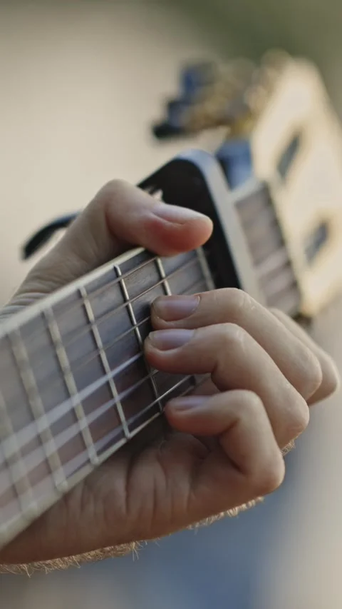 A man plays the guitar - fingers the strings on the fretboard Stock Footage 329547999