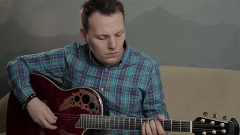 Man plays a guitar Stock Footage 72716700